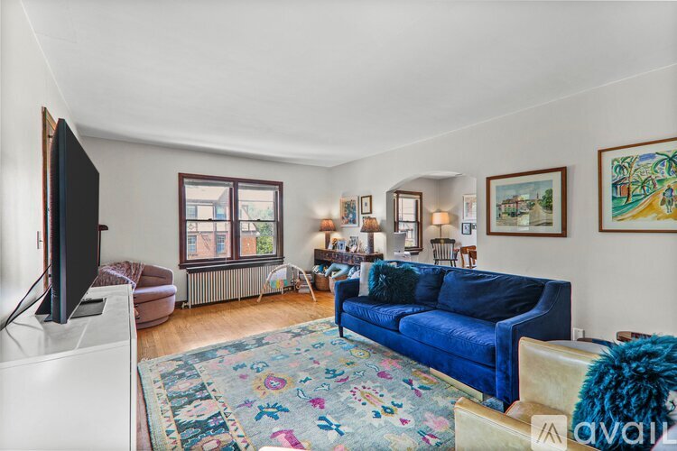 A living room with a blue couch and a television.