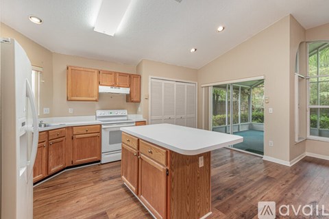 A kitchen with wooden cabinets and a white countertop is available.