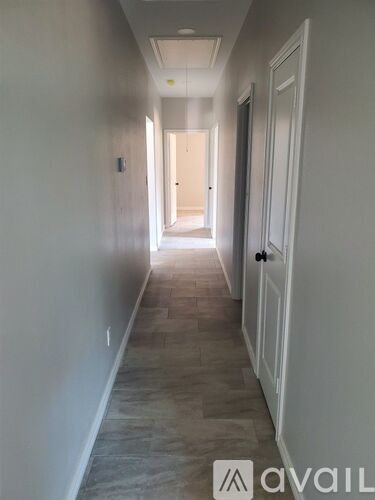 A long hallway with a door at the end.