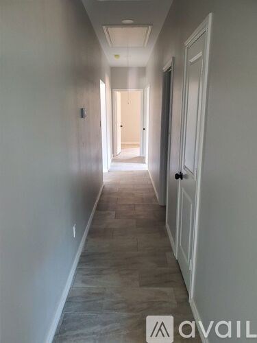 A long hallway with a door at the end.