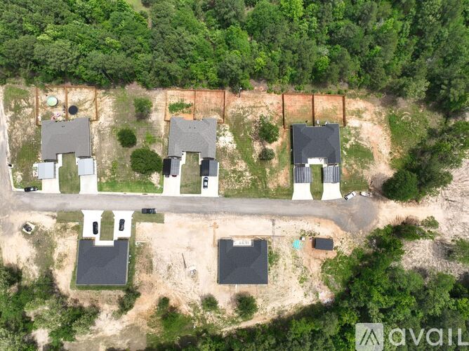 A bird's eye view of a residential area with houses and trees.