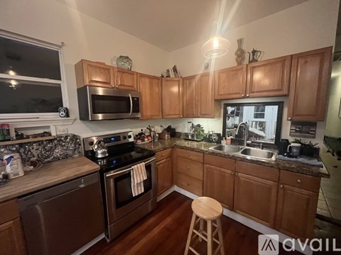 A kitchen with wooden cabinets and a stove top oven.