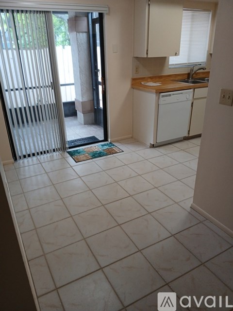 A kitchen with white appliances and cabinets is shown.