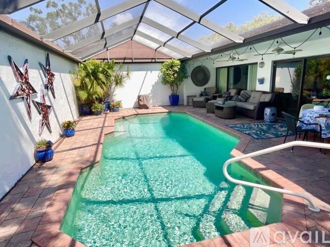 A pool in a backyard with a glass ceiling.