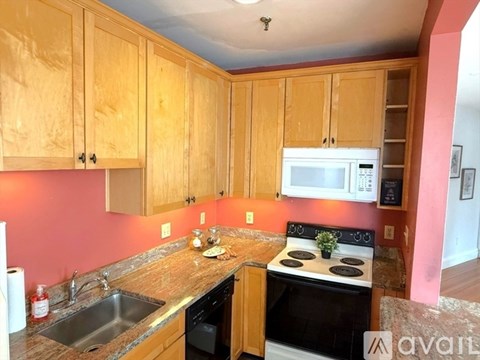 A kitchen with wooden cabinets and a stove top oven.