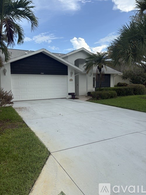 A house with a driveway and garage door.