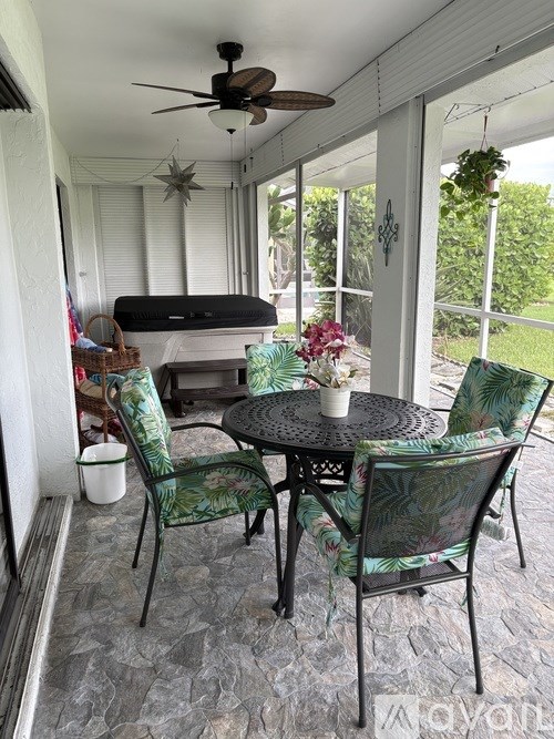 A patio with a table and chairs.