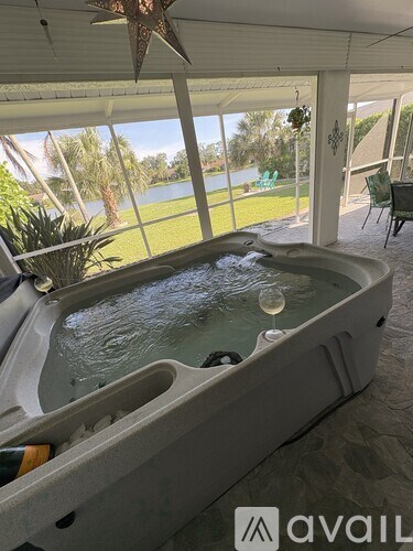 A hot tub is in the middle of a covered patio.