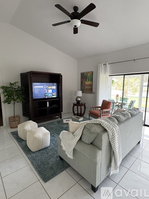 A living room with a grey couch and a television.