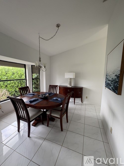 A dining room with a table set for six.