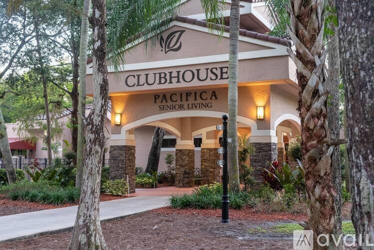 The Clubhouse of Pacifica Senior Living is surrounded by trees.