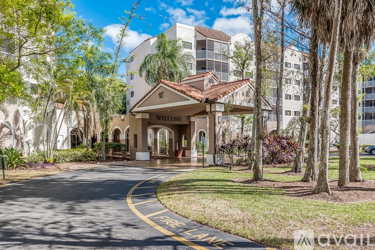 A building with a "Welcome" sign is surrounded by trees.