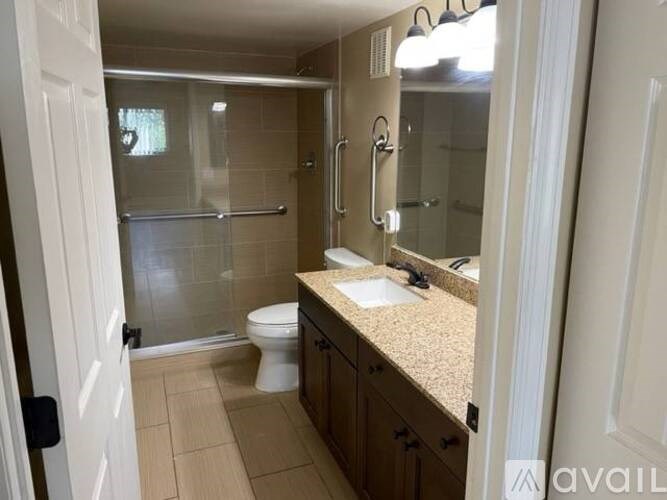 A bathroom with a toilet, sink, and shower.