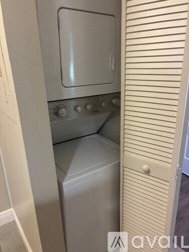 A white oven with a glass door is installed in a kitchen.