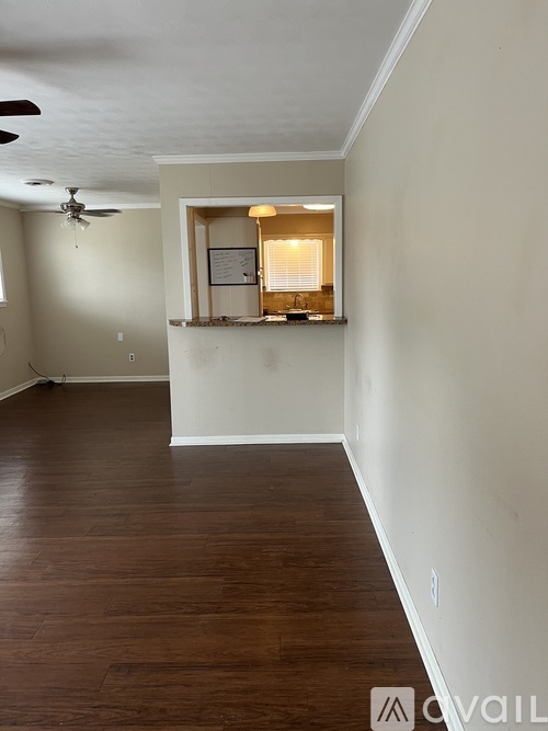 A room with a window and a fan on the ceiling.
