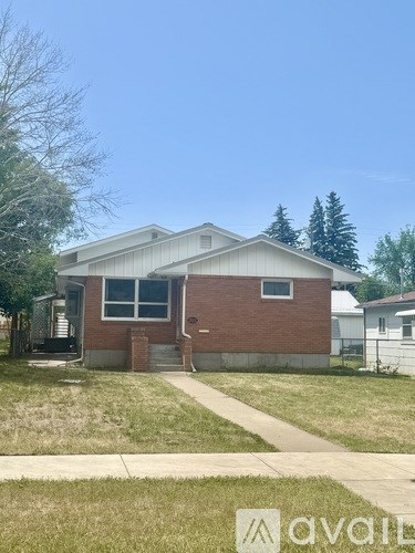 A house with a white garage door and a brick chimney.