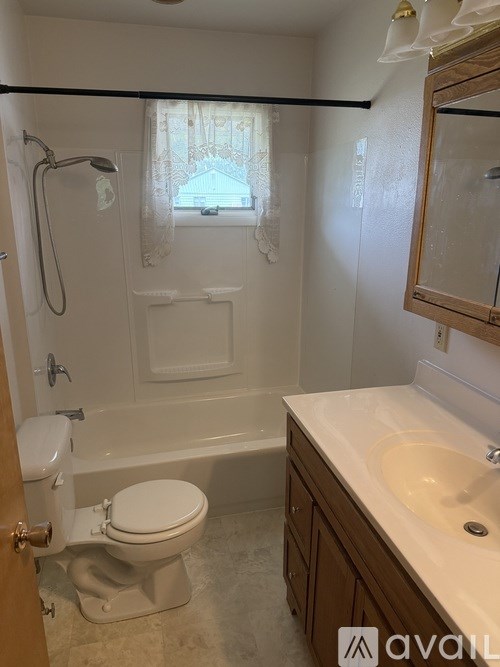 A bathroom with a toilet, sink, and bathtub.