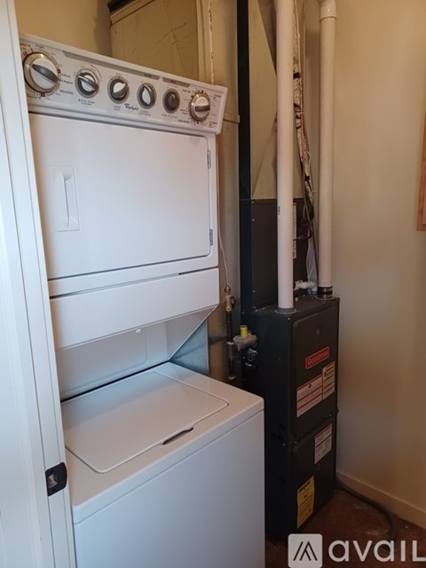 A white dishwasher and oven are installed in a kitchen.