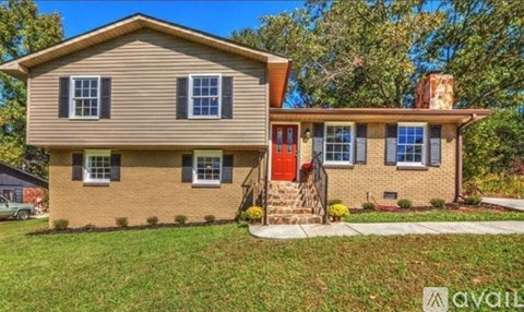 A house with a red door is for sale.