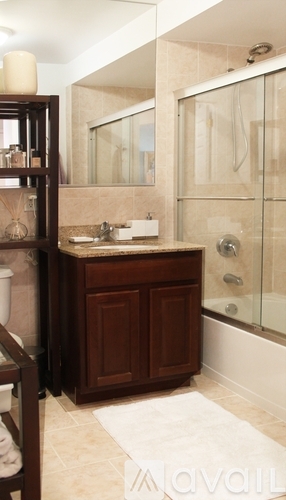 A bathroom with a sink and a shower.