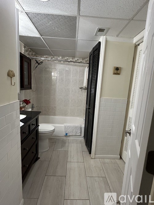 A bathroom with a toilet, sink, and shower.