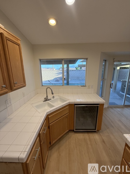 A kitchen with wooden cabinets and a white countertop.