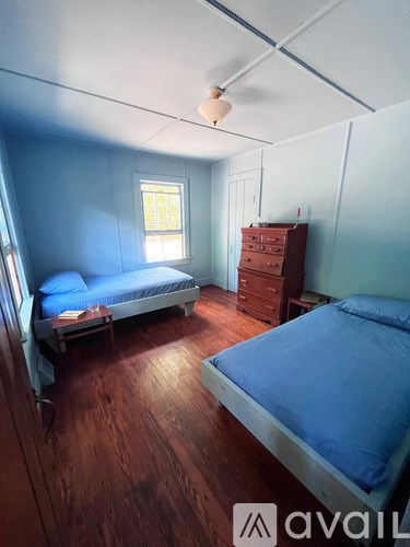 A bedroom with a bed and a dresser.