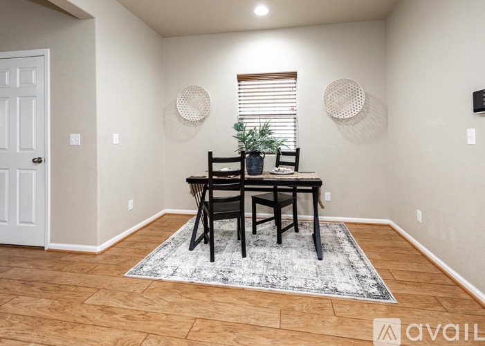 A dining room with a wooden table and chairs.