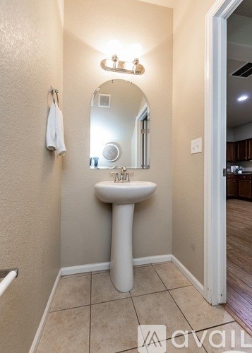A bathroom with a sink and mirror.