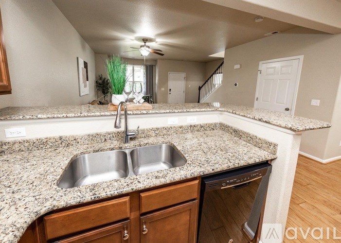 A kitchen with granite countertops and stainless steel appliances.