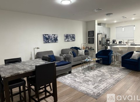 A modern living room with a dining table and chairs.