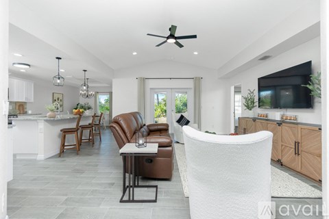 A modern living room with a dining table and chairs.