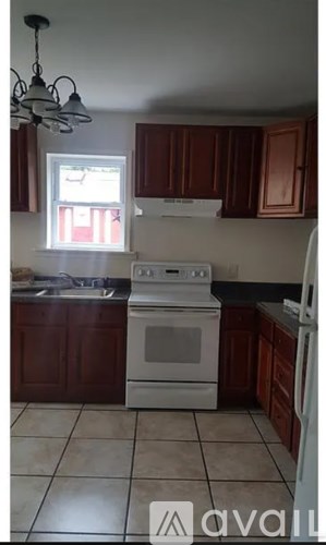 A kitchen with a white oven and sink.