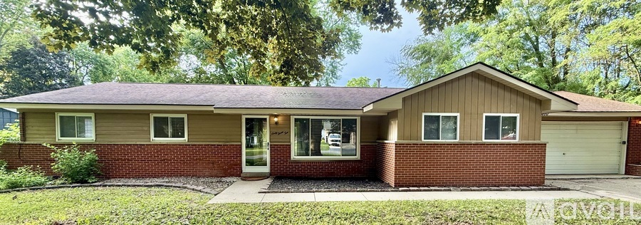 A house with a brown roof and a garage door.