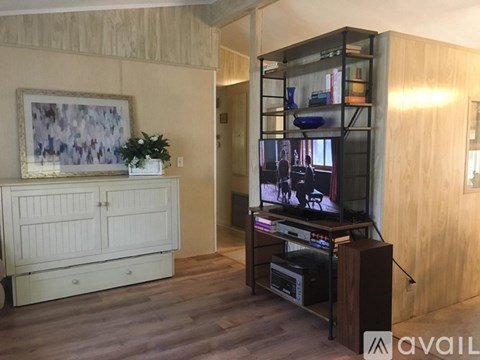 A living room with a television and a cabinet.