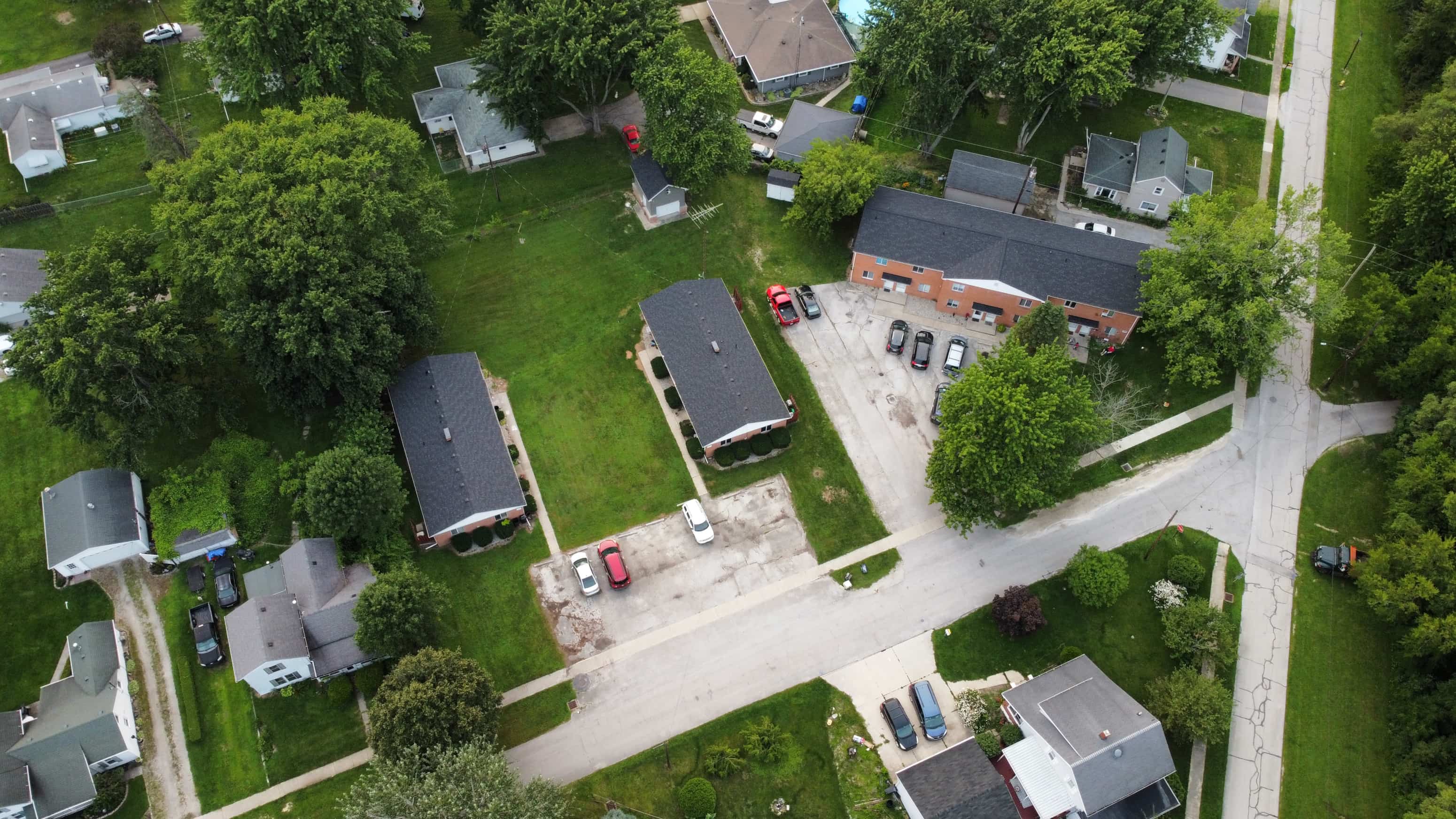 A residential area with houses and cars.
