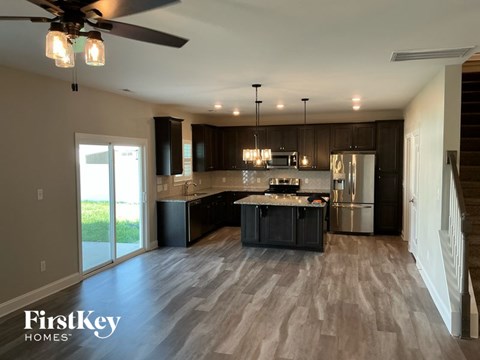 A spacious kitchen with dark wood cabinets and a center island.