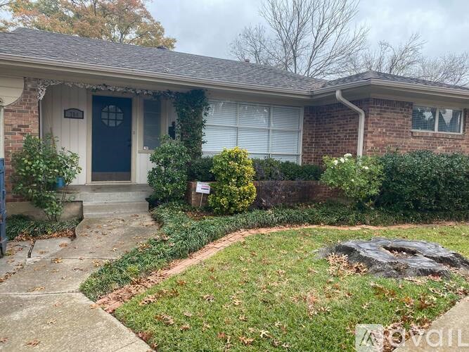 A house with a blue door and a grey garage door.