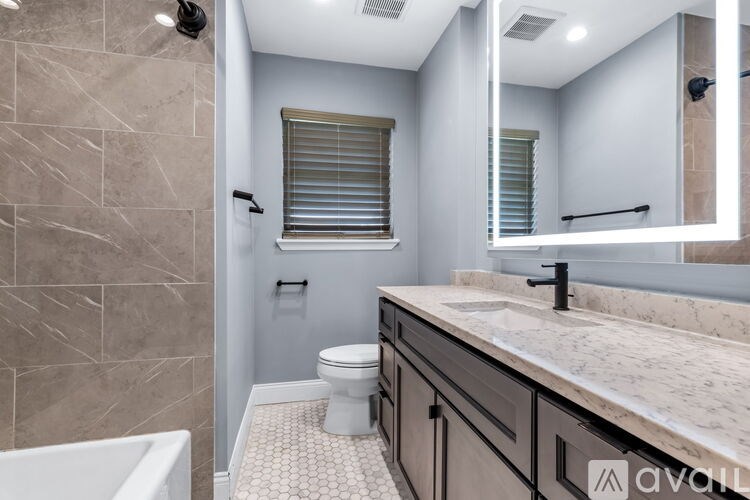 A bathroom with a toilet, sink, and a tub.