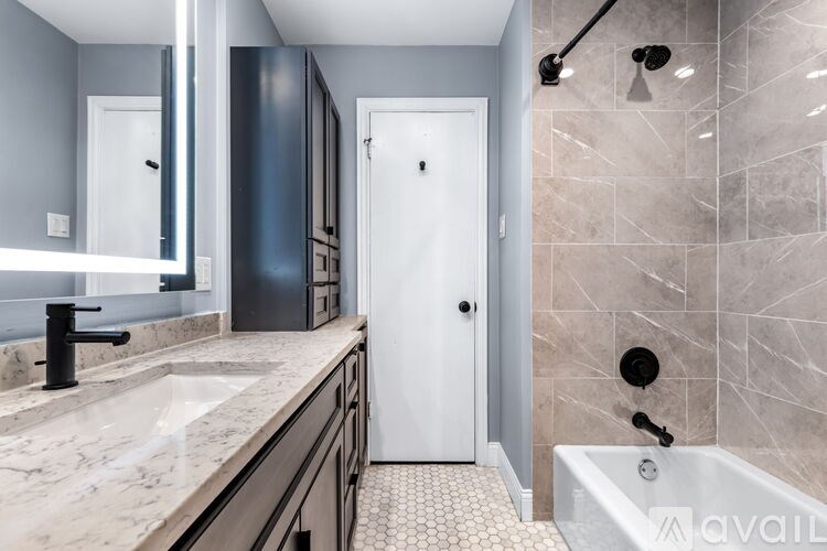 A bathroom with a marble countertop and a white door.