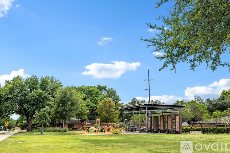A park with a pavilion and playground equipment.