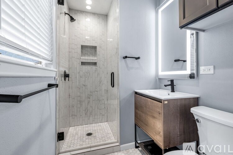 A bathroom with a wooden door and a tiled floor.