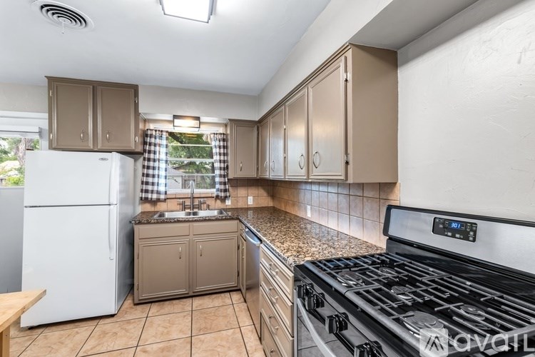 A room with a white cabinet and a shelf with a sign on it.