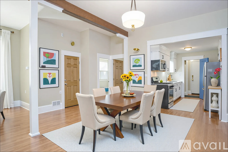 A dining room with a wooden table and chairs.