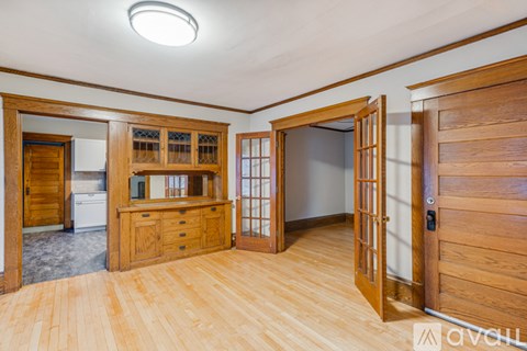 A kitchen with wooden cabinets and a refrigerator.