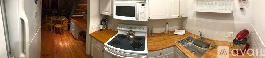 A kitchen with a stove top oven and a microwave above it.