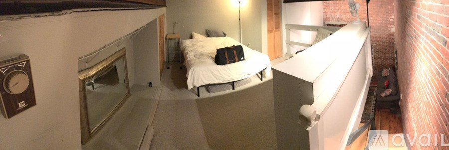 A bedroom with a bed and a window.