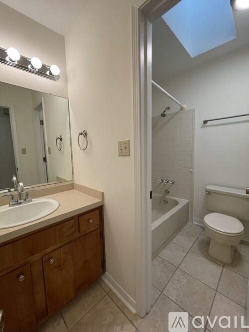 A bathroom with a sink, toilet, and shower.