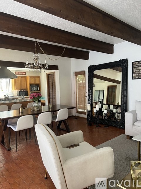 A living room with a dining table and chairs.