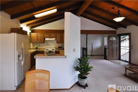 A kitchen with wooden cabinets and a white fridge.